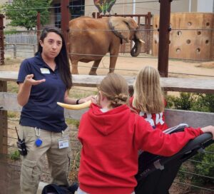 Exhibit Interpreter at Zoo Atlanta in front of the elephant habitat