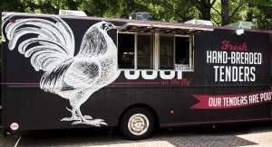 A food truck selling chicken tenders with a large chicken depicted on its side.