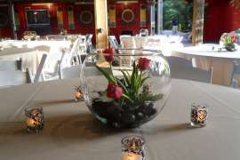 An event space set up with tables, linens and chairs