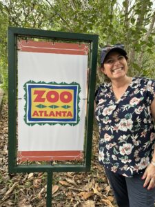 Dr. Gina Ferrie poses next to a Zoo Atlanta sign