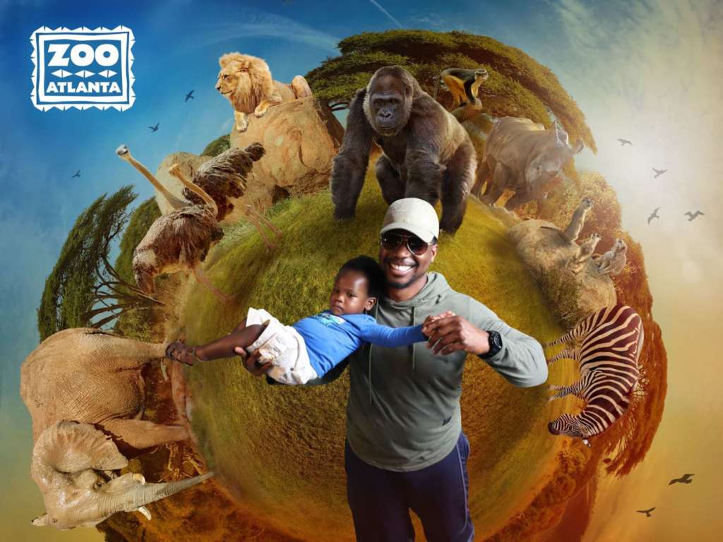 A father and child pose in front of a stylized image featuring a background of zoo animals.