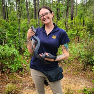 Melissa, Director of Interpretive Planning and Engagement participates in an indigo snake release