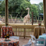Decorated tables in Twiga Terrace with a giraffe