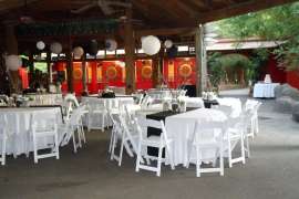 An event space in Panda Veranda set up with chairs, linens and tables