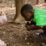 Education instructor with young camper