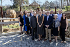 The 2026 Beastly Feast Committee pose in front of the elephant habitat