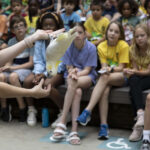 A group of Safari Campers sit in an audience during a World of Wild bird presentation.