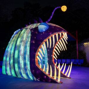 a large fish shaped sculpture with lights