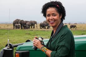 Paula Kahumbu poses with elephants in the background